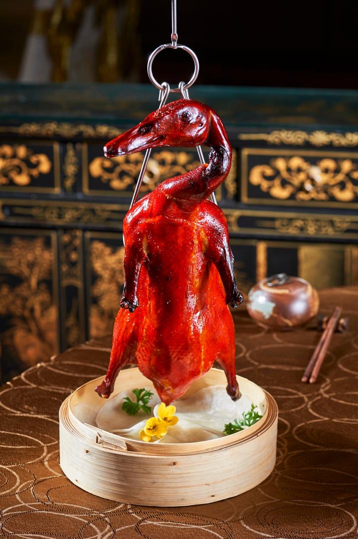 Whole Peking duck on the hook, roasted to lacquer
