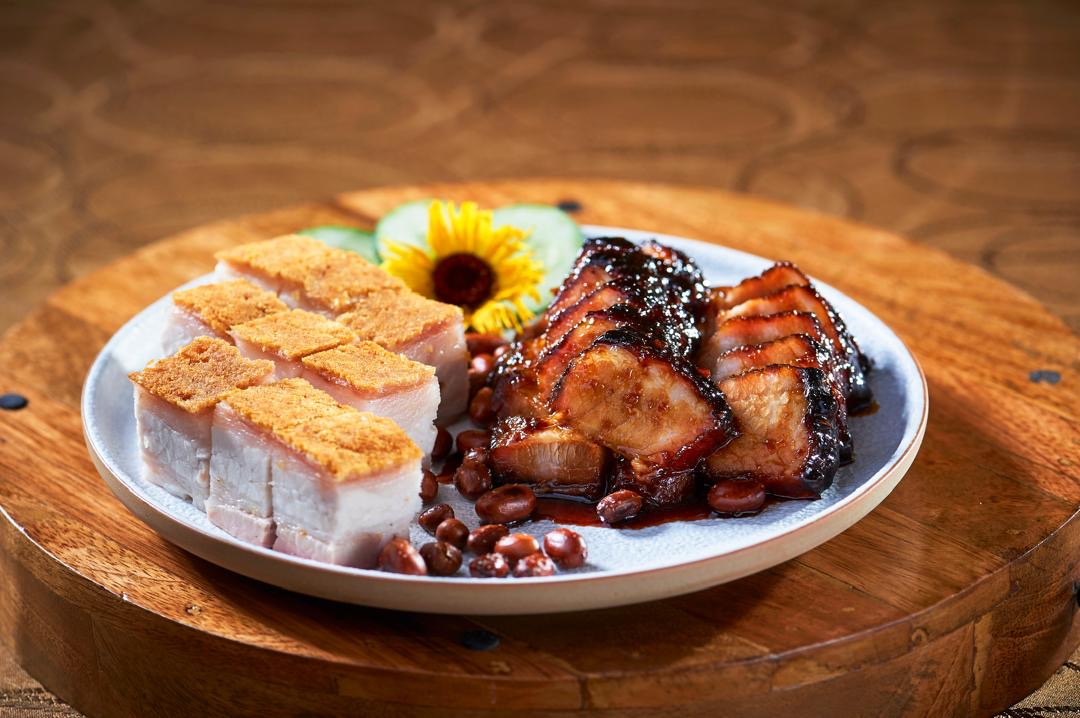 Char siu and siu yuk plated together on stoneware